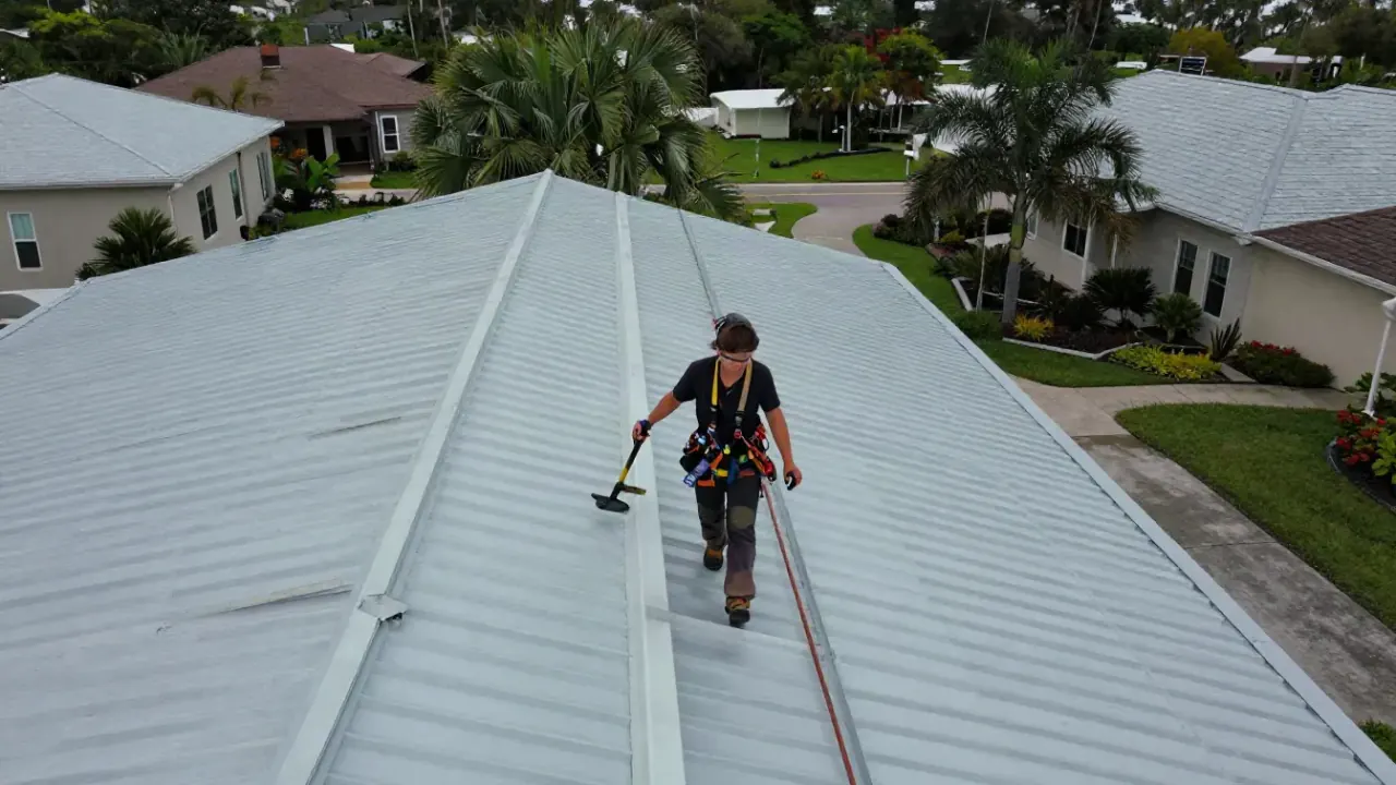 Roof Repair in Sunrise: aerial perspective (drone shot) of a roofer meticulously inspecting a large commercial metal roof