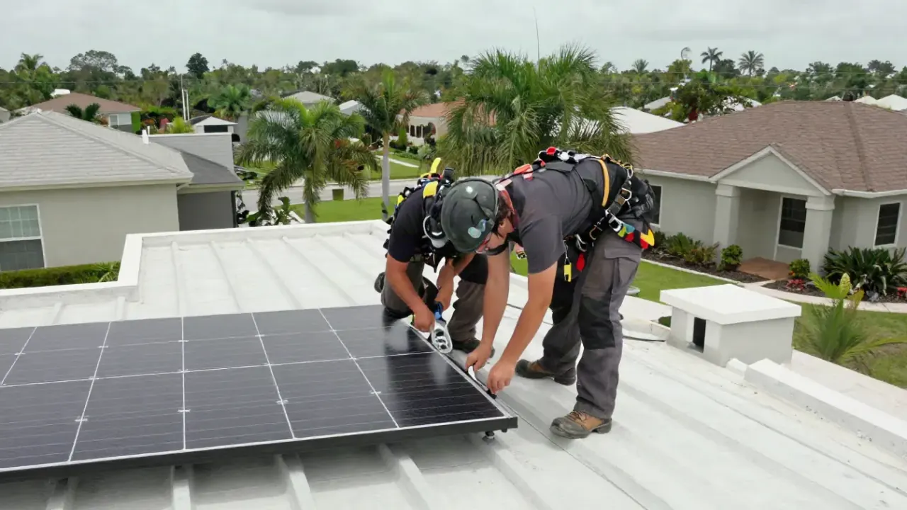 Solar Panel Roof Integration Repair in Sunrise: roofer is tightening a loose bolt on a solar panel rack system on a